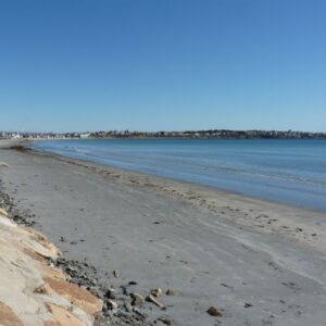 Long Sands Beach image of a sandy shore along the ocean, clear and blue skies