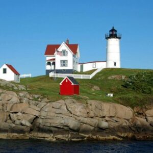 Nubble Light House a white light house and a little red shed on an island