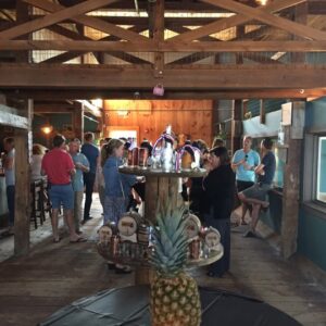 multiple people standing around the wiggly bridge barn during an event