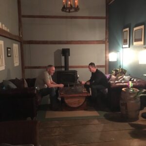 two people sitting across from each other playing cribbage