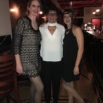 3 woman posing and smiling in a bar event