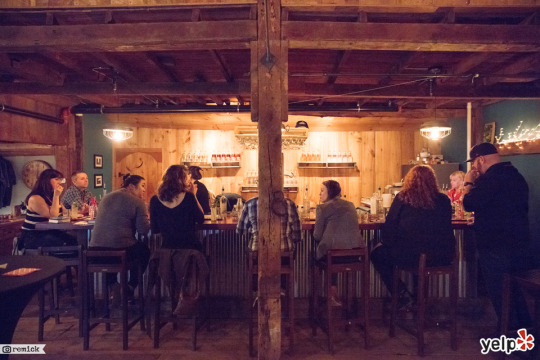 a group of people sitting at the Wiggly Bridge Distillery bar